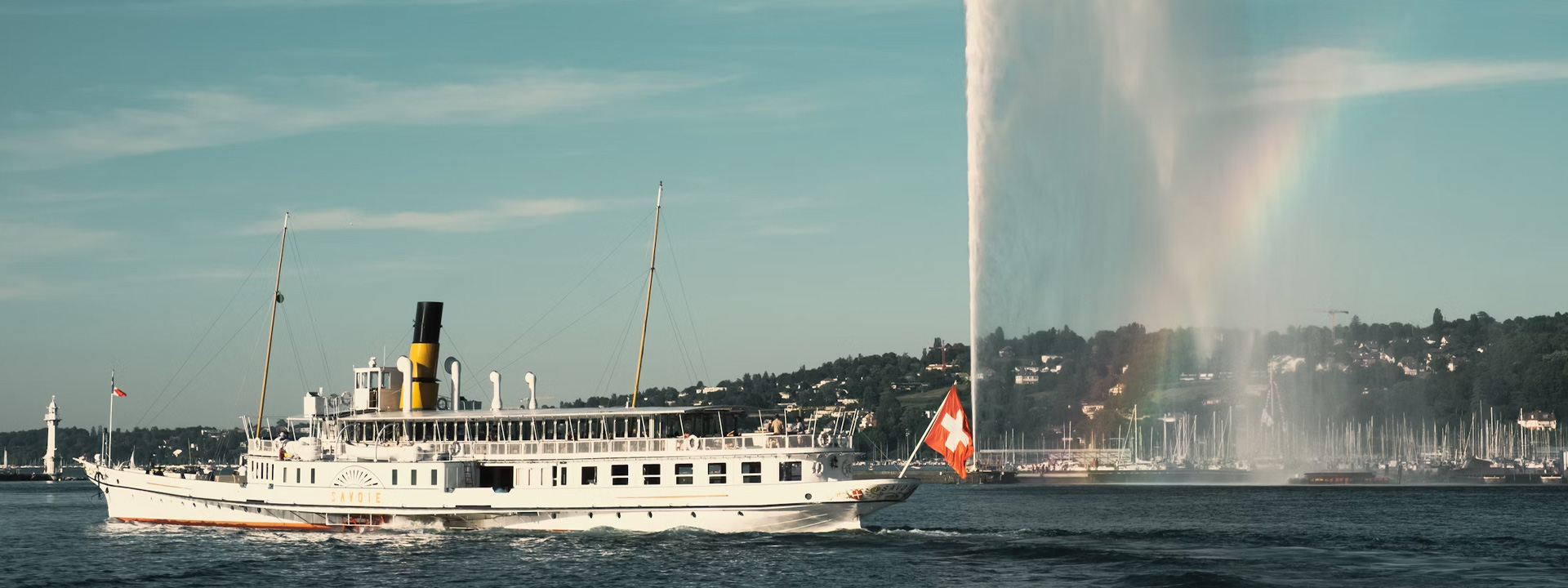 white ship on water fountain under blue sky during daytime