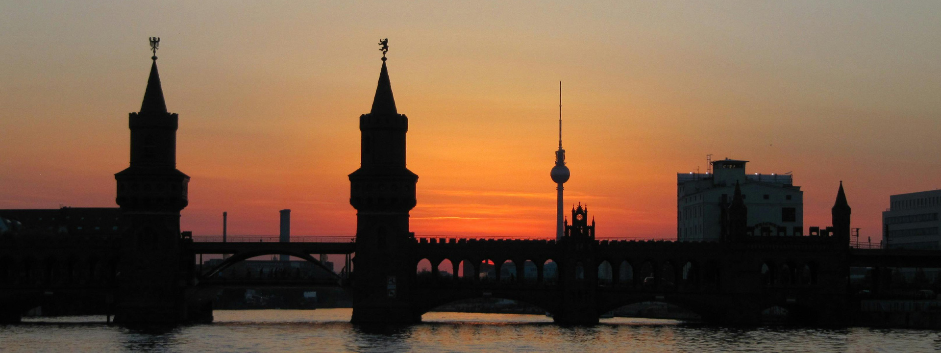 Silhouette of Bridge on Body of Water during Golden Hour