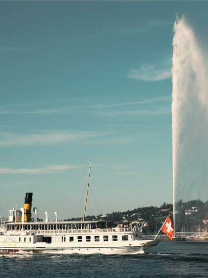 white ship on water fountain under blue sky during daytime