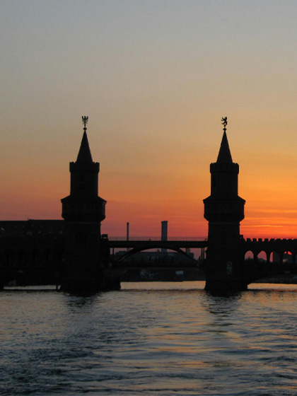 Silhouette of Bridge on Body of Water during Golden Hour
