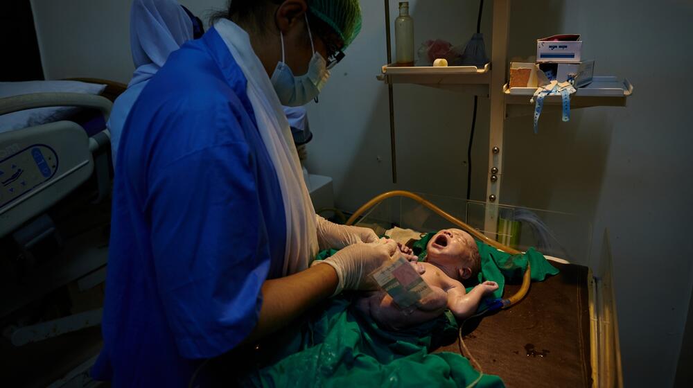 A nurse tends to a newborn baby.