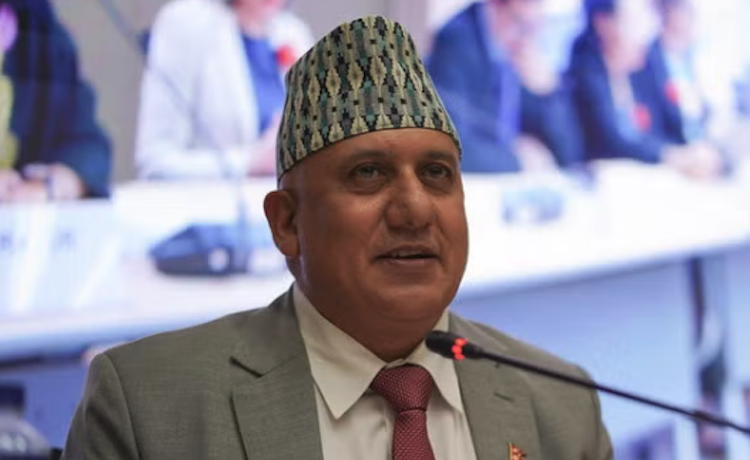 The photo shows Shiva Raj Adhikari speaking into a microphone.