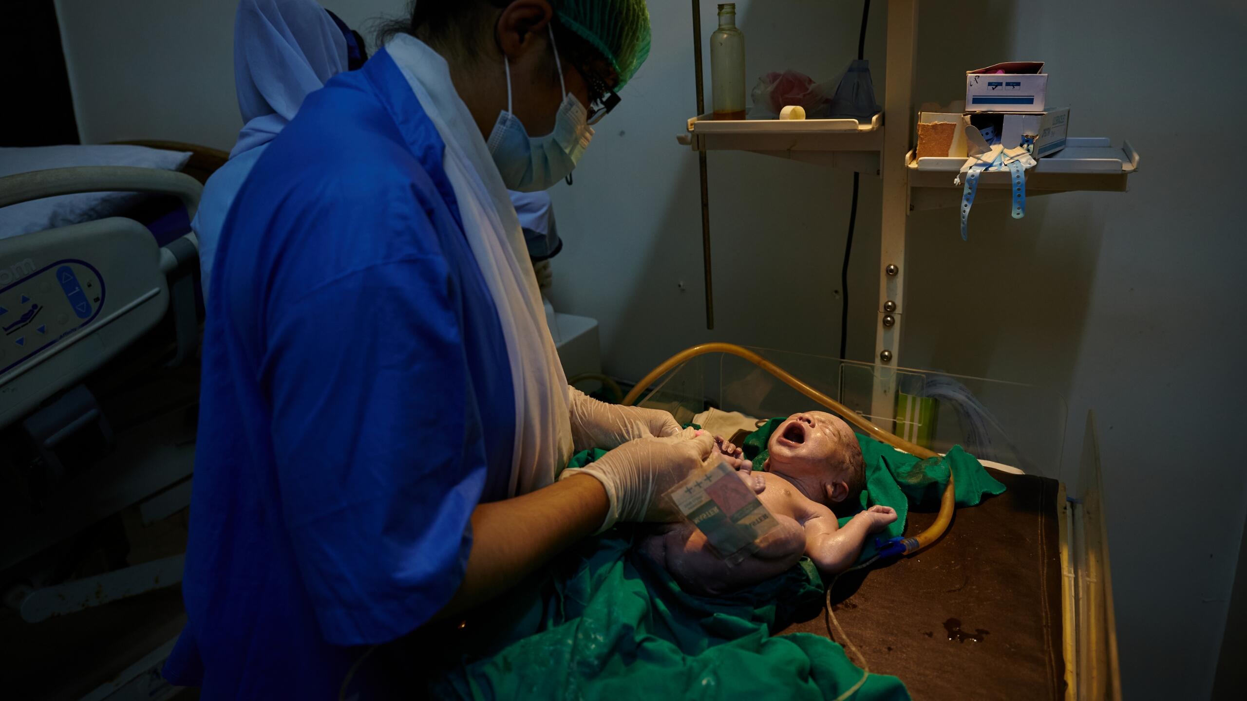 A nurse tends to a newborn baby.