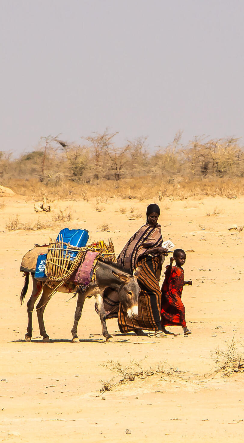 A family travels with their belongings.