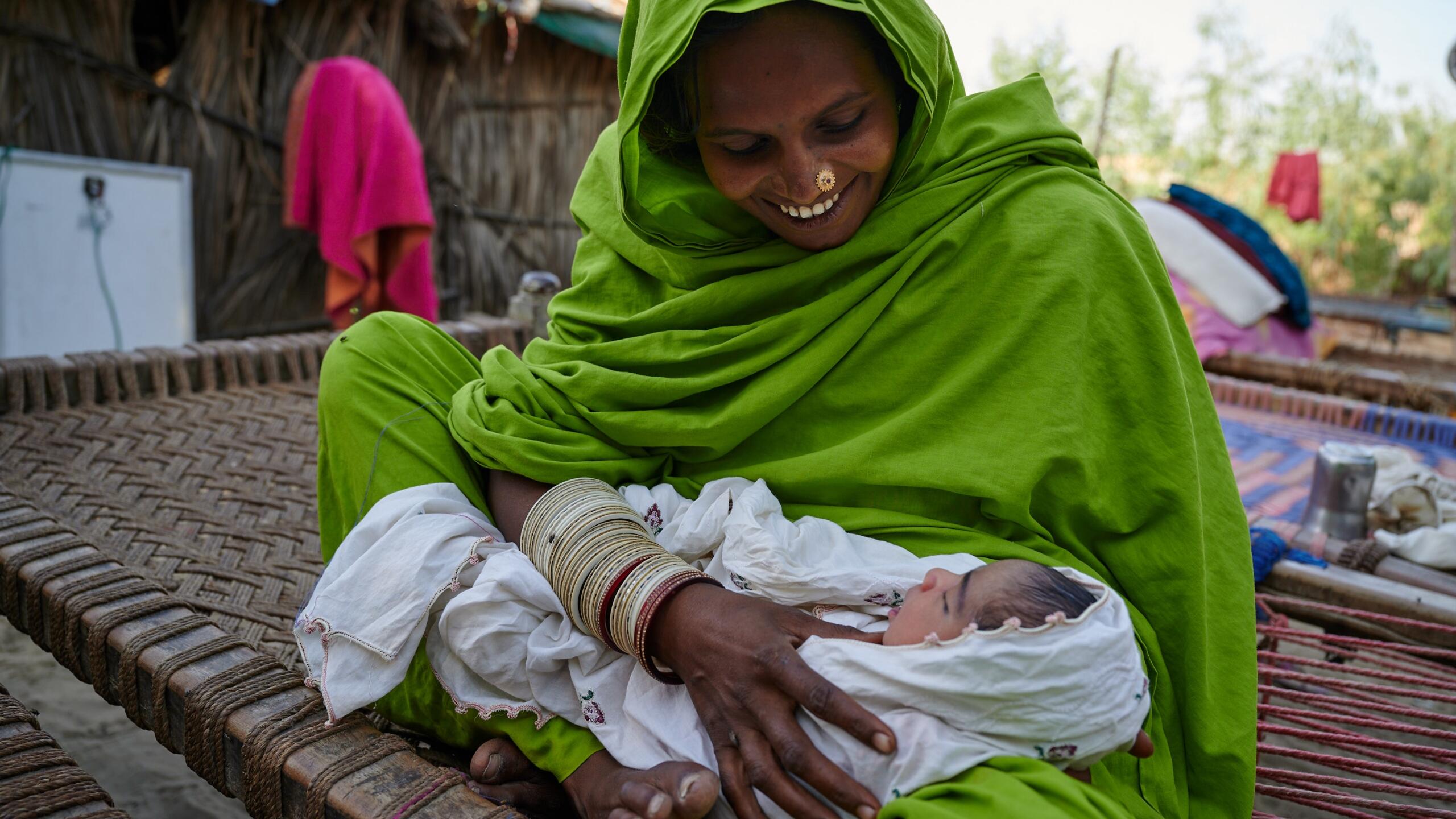 A woman holds her child.