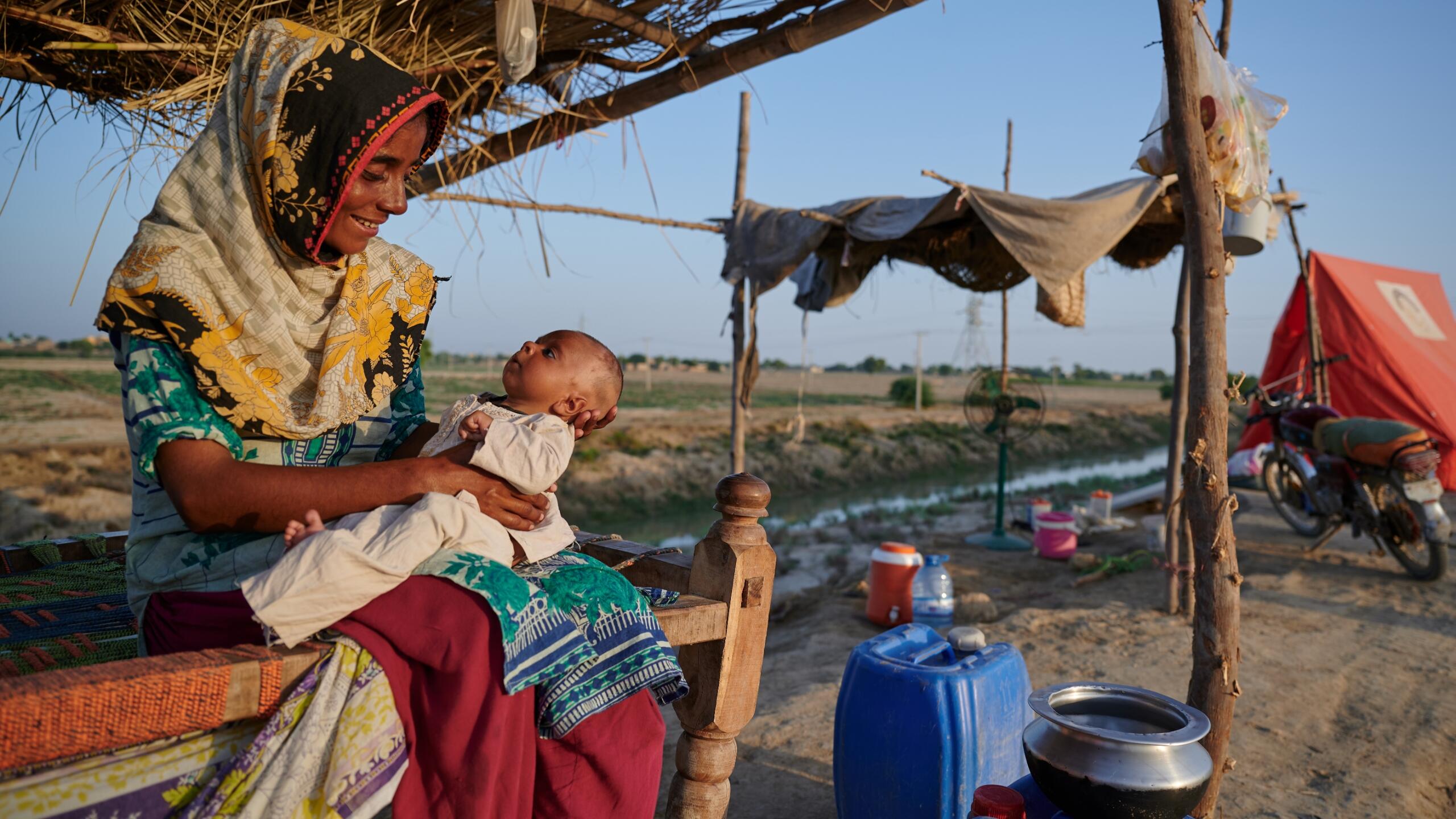 A woman holds her child.