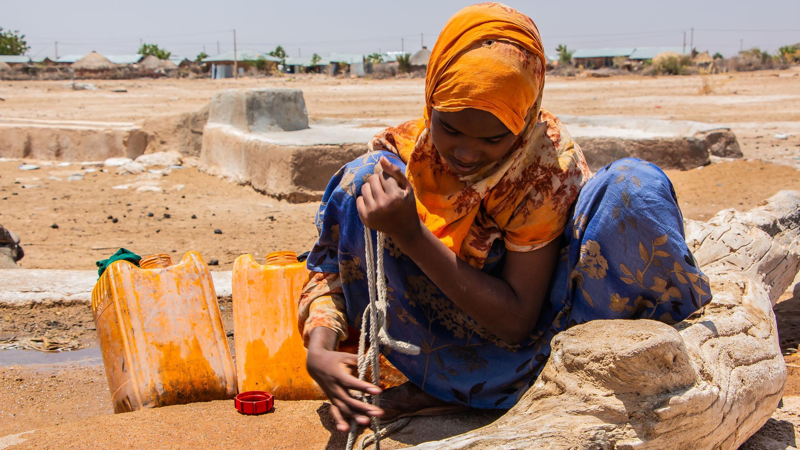 A young woman performs a task.