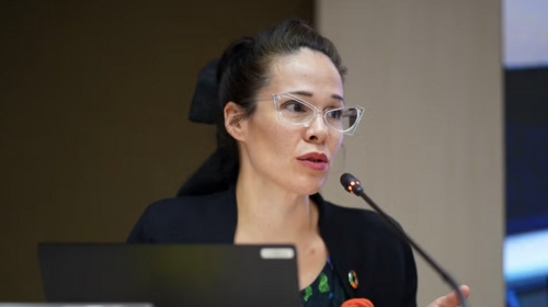 The photo shows Danielle Sever speaking into a microphone.