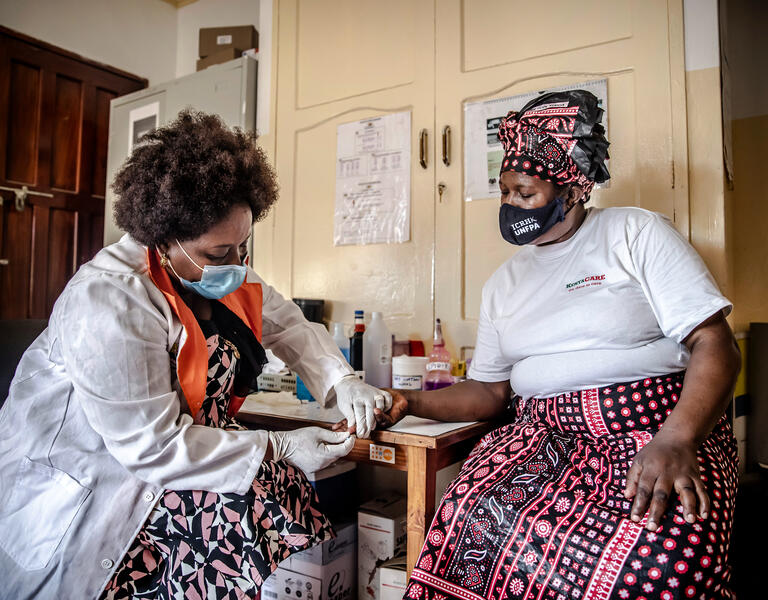 A woman receives a HIV test.